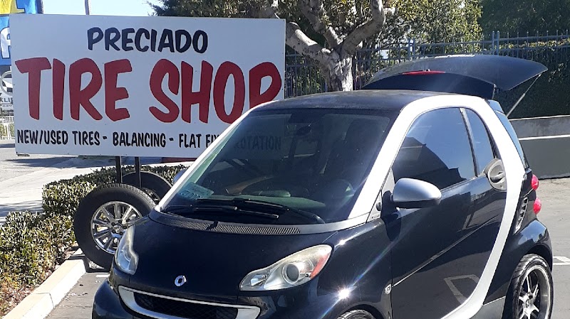 Preciado Tires storefront with custom yellow Hummer H2 and gold wheels