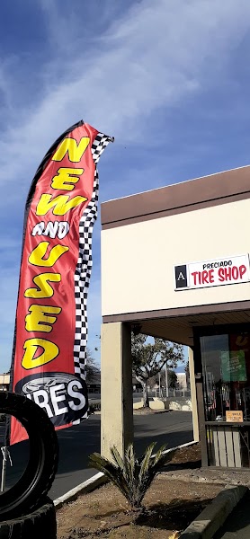 Hand-painted tire mascot on Preciado Tires storefront window