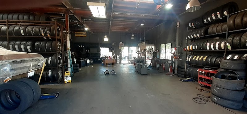 Preciado Tire Shop entrance with checkered banner